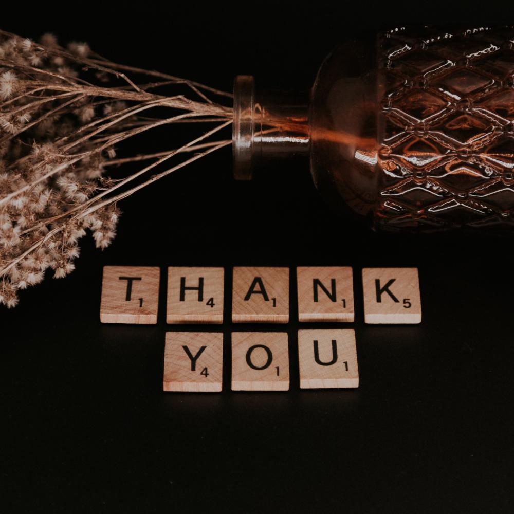 thank you in scrabble letters with a flower